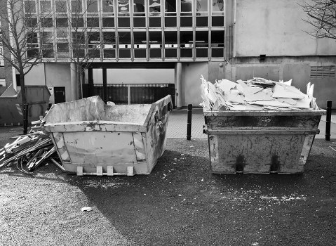 Workers handling building materials for waste removal